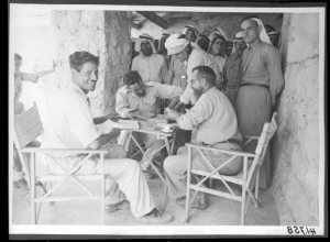 Roland De Vaux and Gerald Lankester Harding with their excavation team. They led the archaeology team surveying the area where the Dead Sea Scrolls were found.