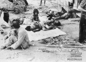 Hiroshima street scence after the atomic bomb. Civilian casualties waiting for medical help.