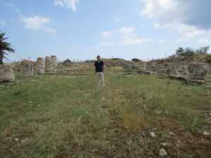 Young Kim standing in the ruins of the Basilica of Epiphanius, in the occupied area.