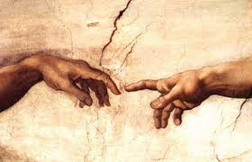 Closeup of fingers touching from the Creation of Adam painting in the Sistine Chapel.