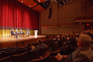 Panelists on stage showing audience.