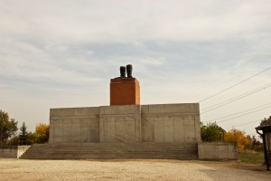 base of a large statue with only feet remaining on the pedestal