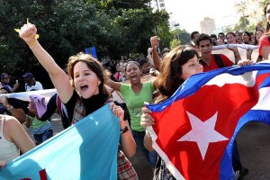 Students holding flags with fists raised in celebration