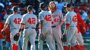 Uniformed baseball players, all wearing number 42
