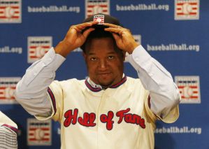 baseball player putting on his cap at a press conference