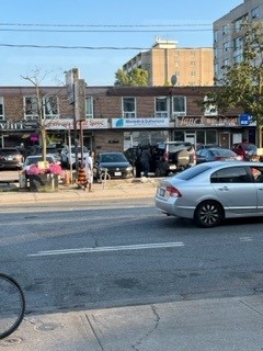Street view of storefronts and barber shops.